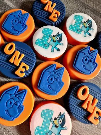Bluey themed chocolate covered Oreos decorated with blue and white character designs